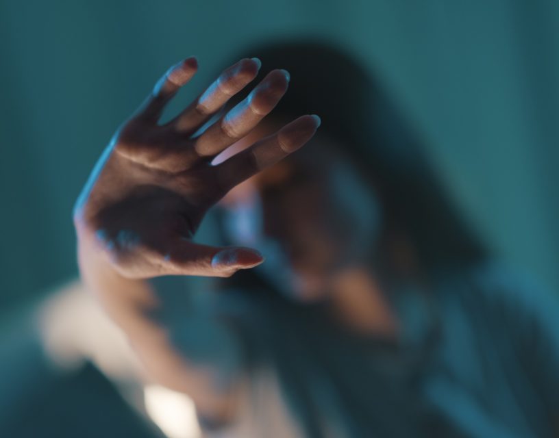 Woman doing a stop sign with her hand.