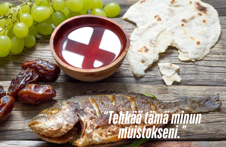 Leipää, viiniä, kalaa ja taateleita pöydällä. Teksti: Tehkää tämä minun muistokseni. 